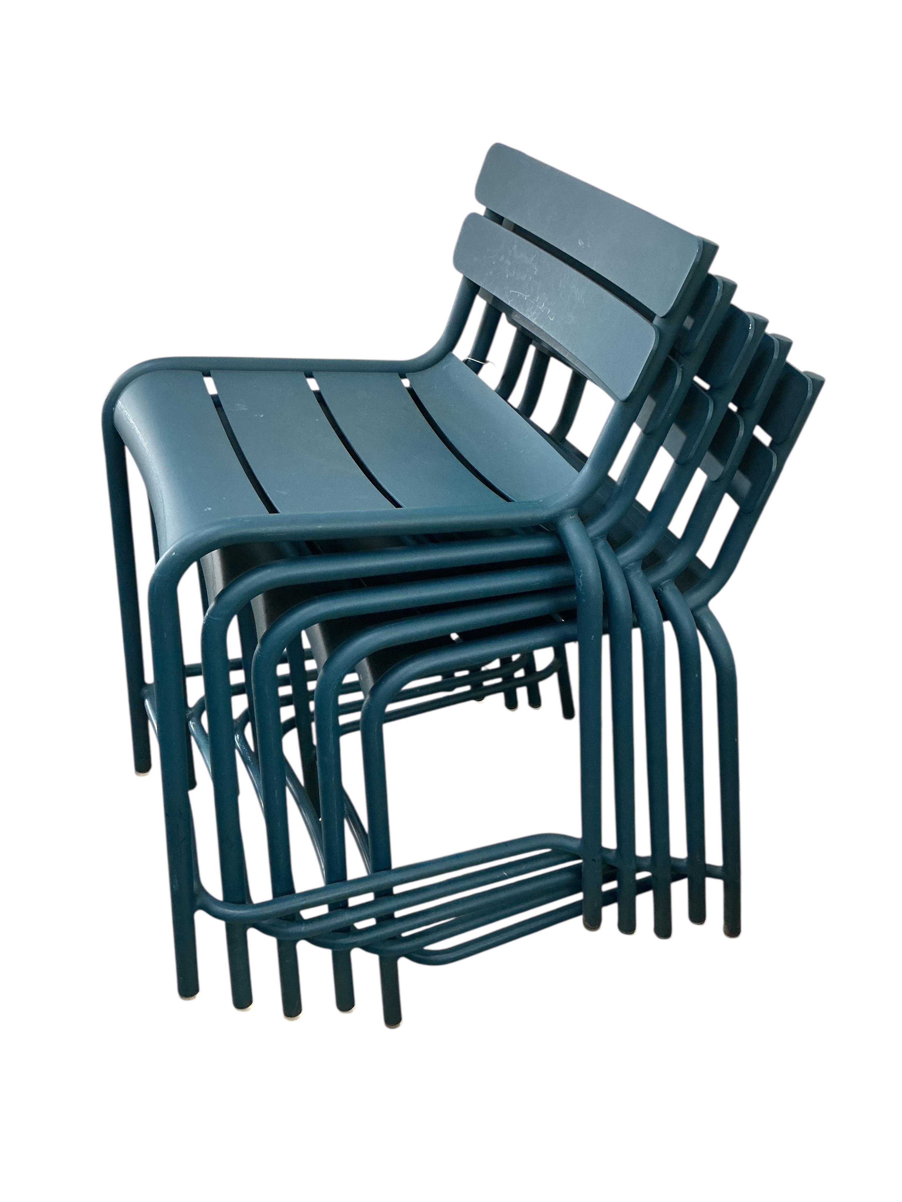 A set of five Fermob blue metal stacking chairs, width 45cm, depth 45cm, height 86cm